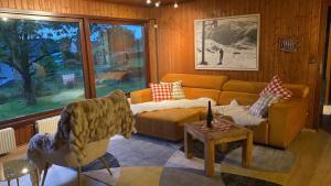 a living room with a couch and a table at Vedder's Berghütte in Herscheid