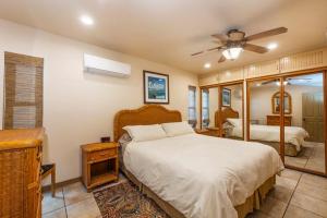 a bedroom with a bed and a ceiling fan at Newport Vacation Memories in Newport Beach
