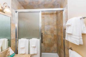 a bathroom with a shower with white towels at Newport Vacation Memories in Newport Beach +19 photos