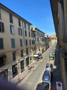 a street with cars parked on the side of the road at Stella / Bergamo center in Bergamo