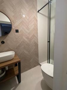 a bathroom with a toilet and a sink and a mirror at Zadar Relax Apartment in Zadar