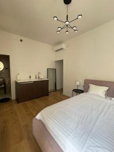 a bedroom with a large white bed and a sink at Zadar Relax Apartment in Zadar