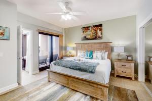 a bedroom with a bed and a ceiling fan at Palm Beach Club 2-228 in Pensacola Beach +27 photos