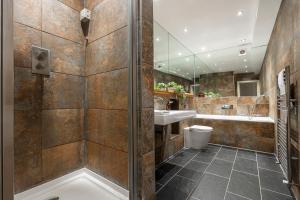 a bathroom with a shower and a toilet and a sink at Fashionable Brick Lane in London