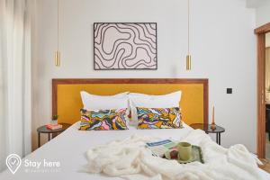 a bedroom with a bed with a blanket on it at Stayhere Casablanca - Gauthier 2 - Contemporary Residence in Casablanca