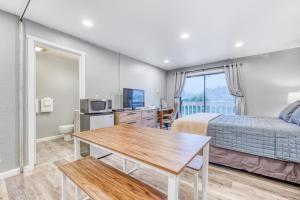 a bedroom with a bed and a desk and a table at Sea Treasures Inn #211 & #212 in Rockaway Beach