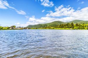 a view of a lake with mountains in the background at Sea Treasures Inn #211 & #212 in Rockaway Beach