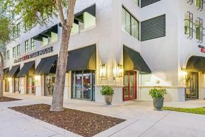 a building with a tree in front of it at Stylish Modern Apartments at Gables Grand Plaza in Miami in Miami