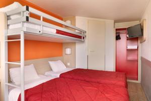 a bedroom with two bunk beds with a red bedspread at Première Classe Châlons-en-Champagne in Saint-Martin-sur-le-Pré