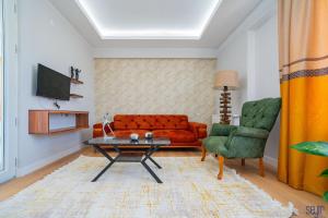 a living room with a couch and a table and a chair at ELEGANCE PRESTİGE in Kayseri