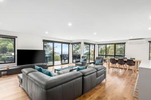 a living room with a large couch and a table at The Wave House in Wye River