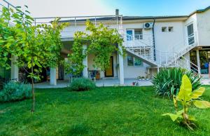 a house with a staircase in the yard at Vila Blue Marine 2 Mai in 2 Mai