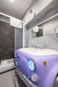 a purple bathroom with a sink and a mirror at Termini Binario 1&2 in Rome