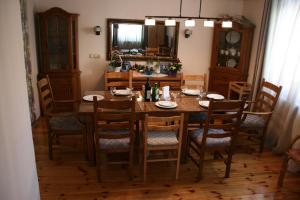 a dining room with a wooden table and chairs at Guest House Sergey in Kolašin