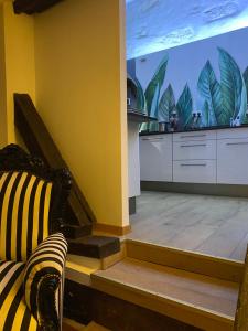 a kitchen with a large window with plants on the wall at Loft i gemelli in Montbéliard