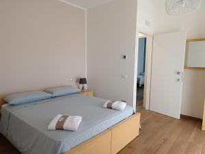 a bedroom with a bed with two pillows on it at dalie's house San Leone Centro in Agrigento