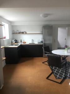 a kitchen with a table and chairs in a room at WINETIME in Oberhausen