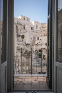 a view of a city from a window at Giù nei Sassi in Matera