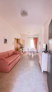 a living room with a couch and a kitchen at Stella marina residence in Lendinuso