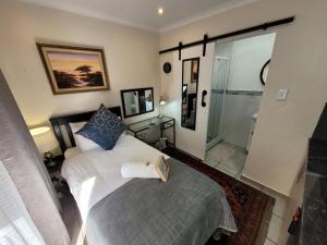 a bedroom with a bed with a book on it at The Oak Potch Guesthouse in Potchefstroom