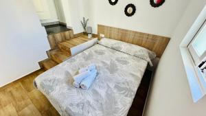 ein Bett mit einem blau ausgestopften Tier, das darauf sitzt in der Unterkunft Apartamento Jimena Málaga en el centro de Nerja in Nerja