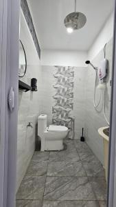 a bathroom with a toilet and a sink at E'dayah Homestay Taman Ria Sungai Petani in Sungai Petani
