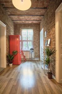 an empty room with a red refrigerator in a brick wall at Taksim square, galata tower historical flat in Istanbul