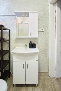 a bathroom with a white sink and a mirror at Taksim square, galata tower historical flat in Istanbul