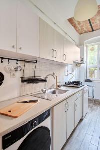 a kitchen with white cabinets and a sink at Taksim square, galata tower historical flat in Istanbul