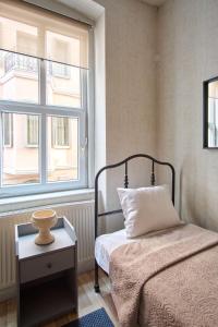 a small bedroom with a bed and a window at Taksim square, galata tower historical flat in Istanbul