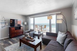a living room with a couch and a television and a table at 3009 Ocean Street- Unit C & D in Carlsbad