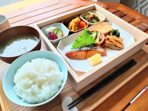 a tray of food with sushi and rice on a table at Green Rich Hotel Tosu Ekimae in Tosu