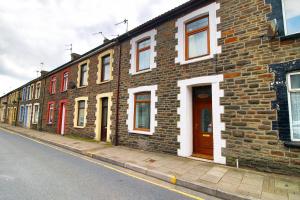 a row of brick houses on the side of a street at K Suites - Robert Street in Trehafod