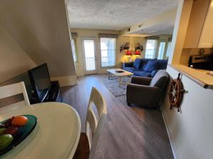a living room with a table and a living room with a couch at North Shore Inn TC 306 in Traverse City