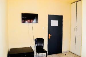 a black door and a black chair in a room at Asmara Hotel in Johannesburg