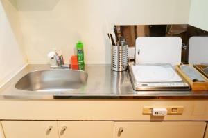 a kitchen counter with a sink and a toaster at Liaison Court Universal Gateway - Free Parking in Osaka