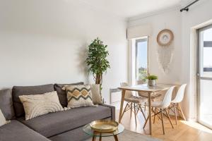a living room with a couch and a table at ALTIDO Bright bohemian flat in Cascais in Cascais