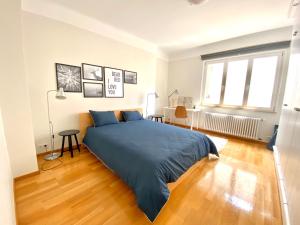 a bedroom with a large bed and a wooden floor at Bars & Culture At Your Doorsteps in Luxembourg