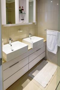 a bathroom with two sinks and a mirror at Studio 1101 iTower in Gaborone