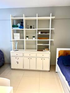 a bedroom with a white shelf and a bed at Departamento en el Centro de Recoleta con pileta, parrilla, gym y laundry in Buenos Aires