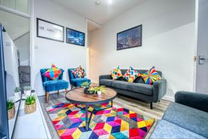 a living room with two couches and a table at K Suites - Madeley Road in Birmingham