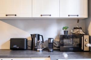 a kitchen counter with various appliances on a counter top at Dalie Luxury Suites in Gouvia