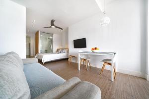 una sala de estar con un sofá y una mesa en Estudio con terraza vista mar, en Las Palmas de Gran Canaria