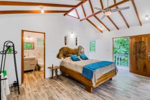 a bedroom with a large bed and a bathroom at Lost Pools Bungalows in Ojochal