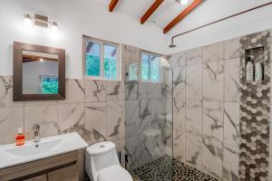 a bathroom with a shower and a sink at Lost Pools Bungalows in Ojochal +27 photos