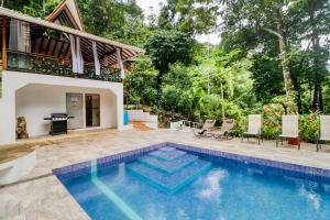 a swimming pool in the backyard of a villa at Lost Pools Bungalows in Ojochal