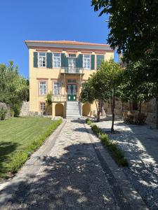 a large house with a walkway in front of it at Eleana Residence in Mythimna