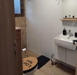 a bathroom with a toilet and a sink at VILA ANÐELIJA Zaovine in Lazići +28 photos