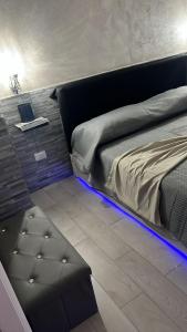 a bedroom with a bed with a blue led lighting at La piccola casetta del centro in Palermo
