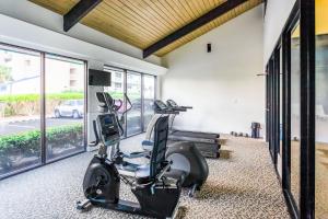a gym with a treadmill and a elliptical machine at White Caps 203 in Orange Beach